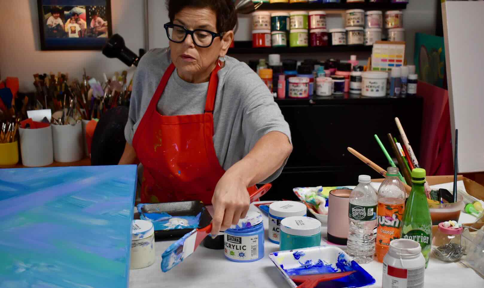 Mary Joy Murphy painting in her studio